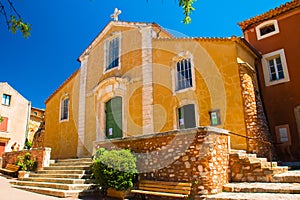 Colorful and ochre church in the Roussillon village, Provence, France