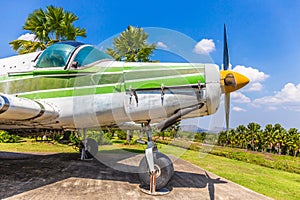 Colorful old airplane at park with gree tree and blue sky