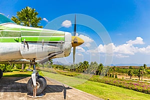 Colorful old airplane at park with gree tree and blue sky background.