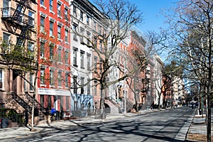 Colorful old buildings line the empty sidewalks along 10th Street in New York City