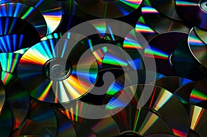 Colorful old CD DVD optical disk storage medium with dust. Dark image