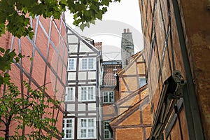 Colorful old town street with wooden rustic houses, typical Danish capital architecture