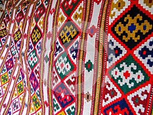 Colorful and oriental shapes on the carpet rug presented in eastern style and made of natural wool with national and ethnic