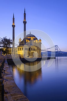 Colorful Ortakoy mosque and Bosphorus Bridge reflection on the sea