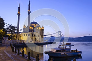 Colorful Ortakoy mosque and Bosphorus Bridge reflection on the sea