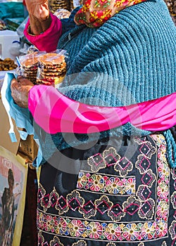 The colorful outfit of the seller of cookies and sweets, Portugal.