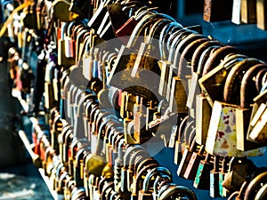 Colorful padlocks on the bridge of a river