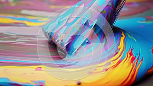 Colorful paint creating rainbow pattern spread with brush