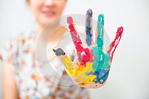 Colorful paint hand with hi 5 gesture of smiling Asian woman