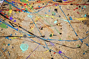 Colorful paint swirl on concrete background.