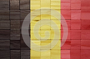 colorful painted big national flag of belgium on a wooden cubes texture