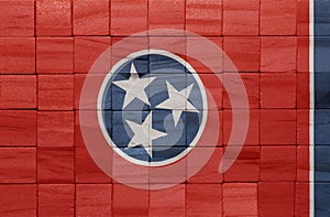 colorful painted big national flag of tennessee state on a wooden cubes texture