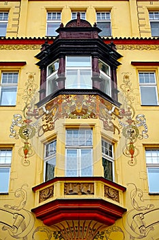 Colorful painted building facade with a beautiful bay window in the Old Town of Prague