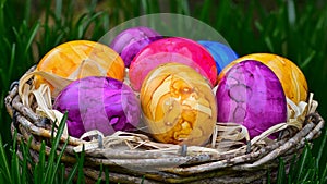 Colorful painted easter eggs in basket