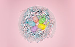 Colorful painted easter eggs in paper nest