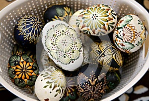 Colorful painted eggs in a nest of twigs of willow on a light background. Traditionally for Easter. Lithuania