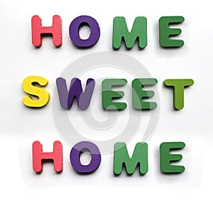 colorful painted wood word sweet home made from many wooden letters isolated on white background. lettering typography poster.