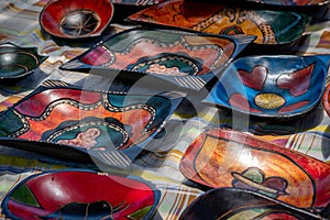 Colorful painted wooden bowls in market