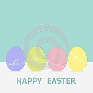 Colorful painting Easter egg set. Row of painted eggs shell with thread and bow. Light color. Blue background. Isolated. Greeting