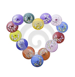 Colorful painting umbrellas on heart shape isolated