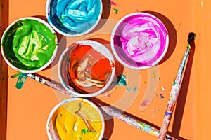 Colorful Paints Sit In Containers For Kids To Paint With