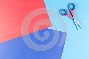 Colorful paper with child`s scissors