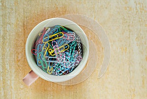 Colorful paper clip in mug