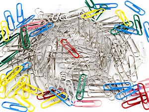 Colorful paper clip and ordinary clips on white background.