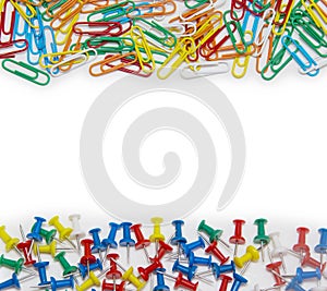 Colorful paper clip and pin on white background
