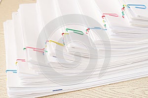 Colorful paper clip with step stack of overload paper