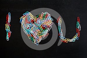 Colorful paper clips forming an alphabets and heart shape