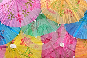 Colorful paper cocktail umbrella close-up