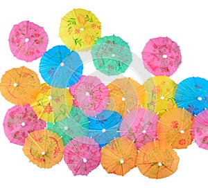 Colorful paper cocktail umbrellas close-up on a white