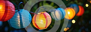 colorful paper lanterns light up a string in a colorful design