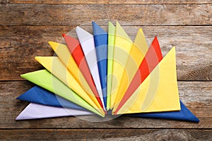 Colorful paper napkins on wooden background