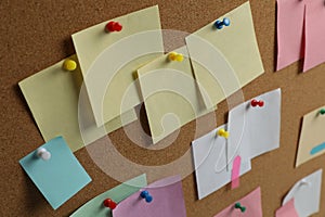 Colorful paper notes pinned to cork board