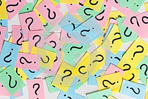 Colorful paper notes with question marks. Closeup