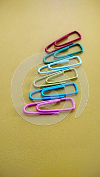 Colorful of Paperclip on yellow background