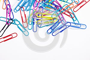 Colorful paperclips frame on white background with copy space