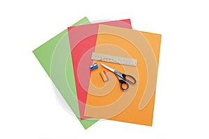 Colorful papers, scissors, pencil sharpener, ruler