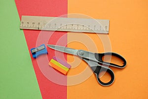 Colorful papers, scissors, pencil sharpener, ruler