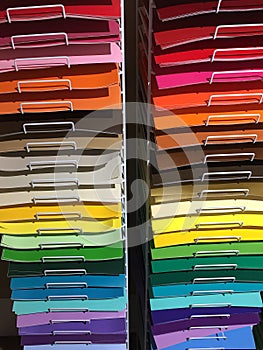 Colorful papers on shelves for sale