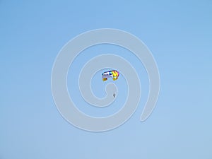 Colorful parachute over blue sky background