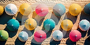 colorful parasols, beach umbrellas in resort sand. top view