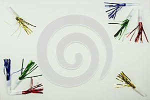 Colorful party noise makers border on white