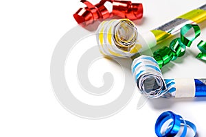Colorful party noise makers on a white background