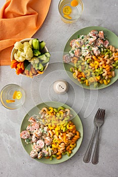 Colorful pasta with boiled sausages