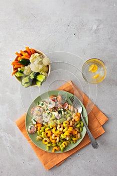 Colorful pasta with boiled sausages