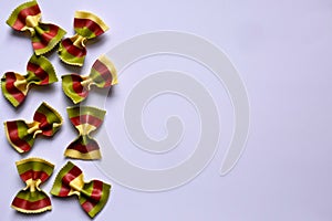 Colorful Pasta, Loop Noodles, Italian Pasta, eight Farfalle.  Closeup, confused in front of white background