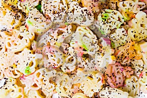 Colorful pasta with poppy seeds on a plate